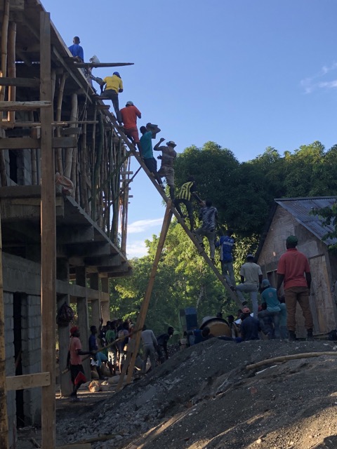 Double length ladder made by the carpenters, going from the ground up to the 30 foot high roof.