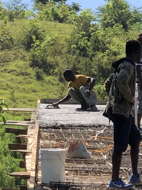 Smoothing out the surface of the roof with a wooden trowel