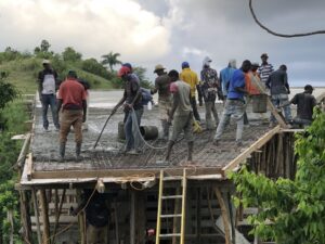 Trying to pour the final portion of the roof before the rain begins.