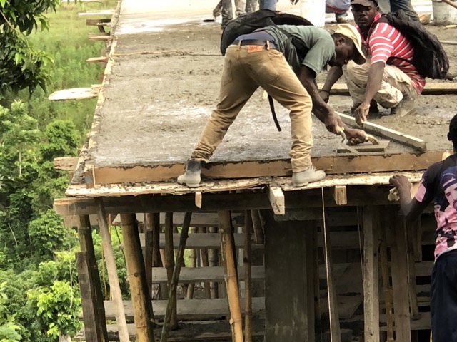 Galate smooths out the corner of the roof as he balances on the edge.