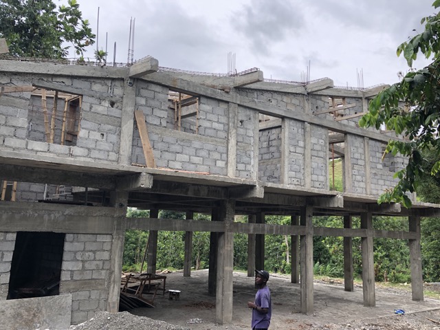 Side view of sloping upper beams. Below is the auditorium portion of the spiritual center.