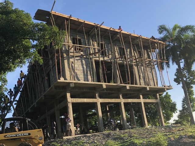 Workers were already on the ladder leading up to the second floor roof (to the left in the photo) when we arrived in the morning.