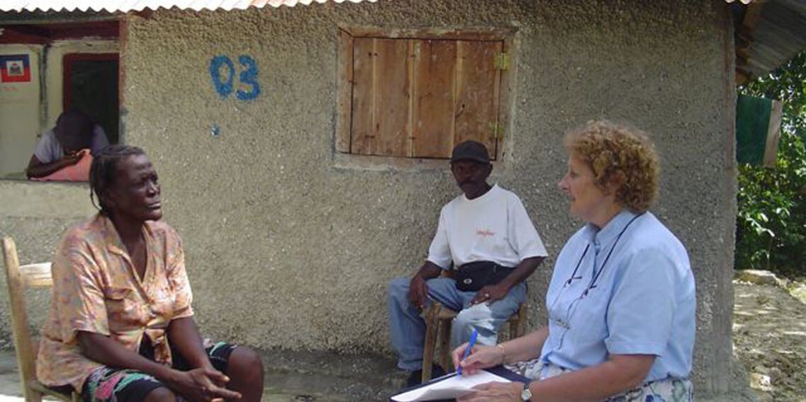 Dr. Wolf interviews a woman during the need and resource assessment  2007.