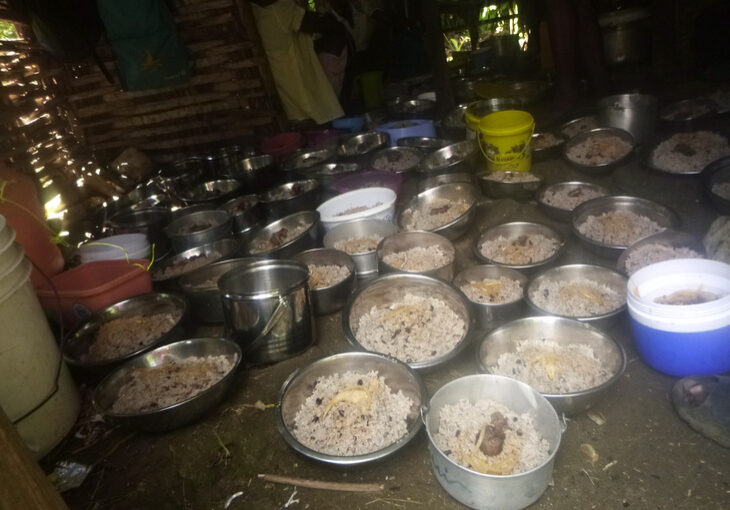 Plates of rice, beans and goat meat await participants in the seed program